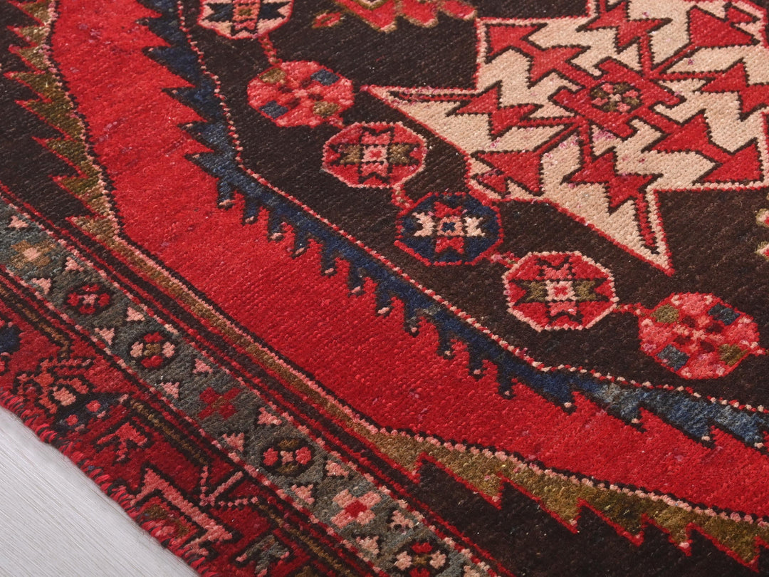 a close up of a red rug with a star on it