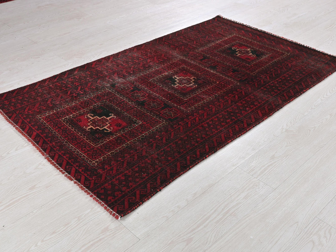 a red rug on the floor of a room