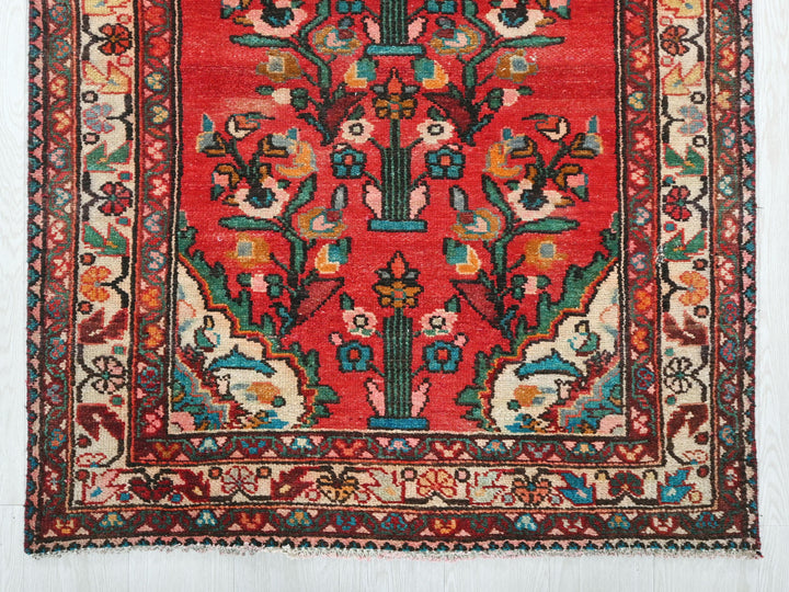 a red rug with a floral design on it