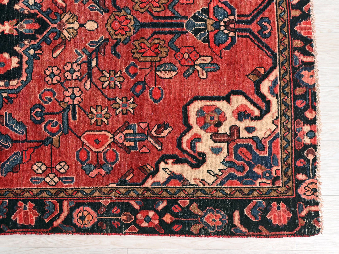 a red oriental rug with a black border