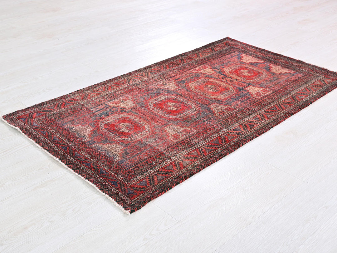 a red oriental rug on a white floor