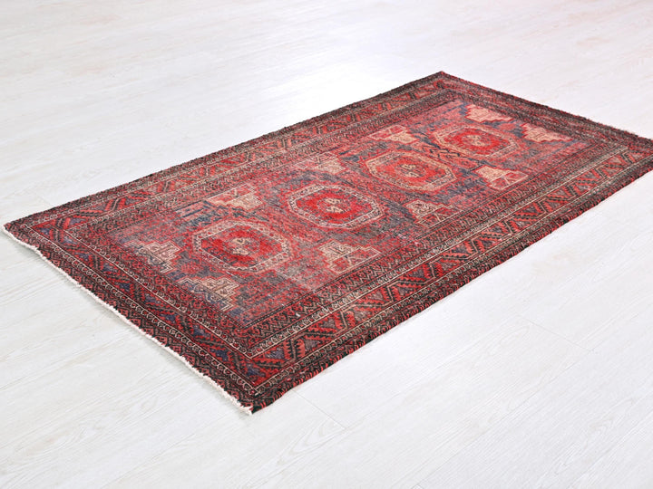 a red oriental rug on a white floor