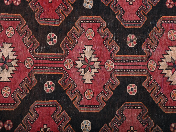 a close up of a red and black rug