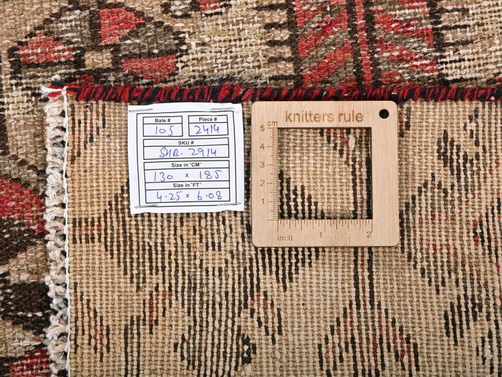 a ruler and a piece of wood sitting on top of a rug