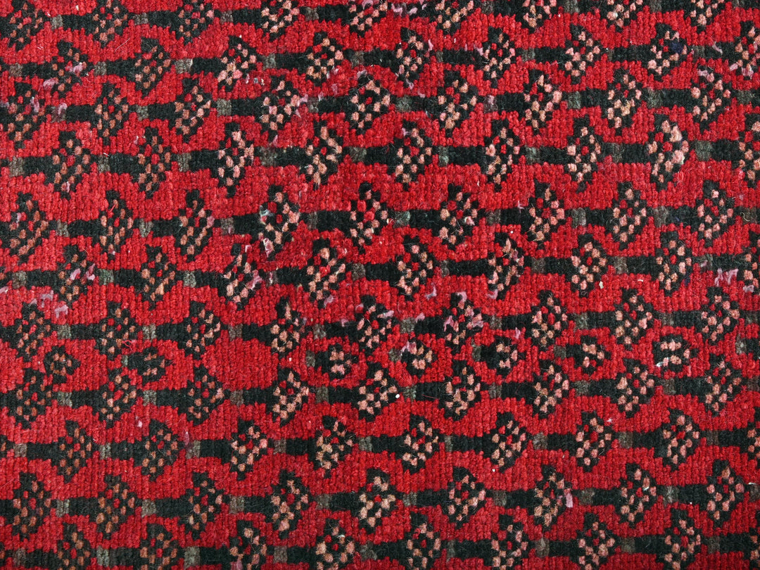 a close up of a red and black rug