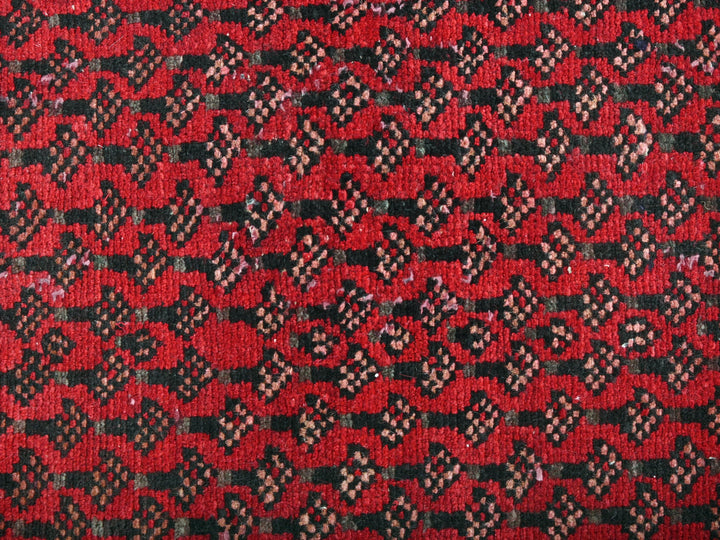 a close up of a red and black rug