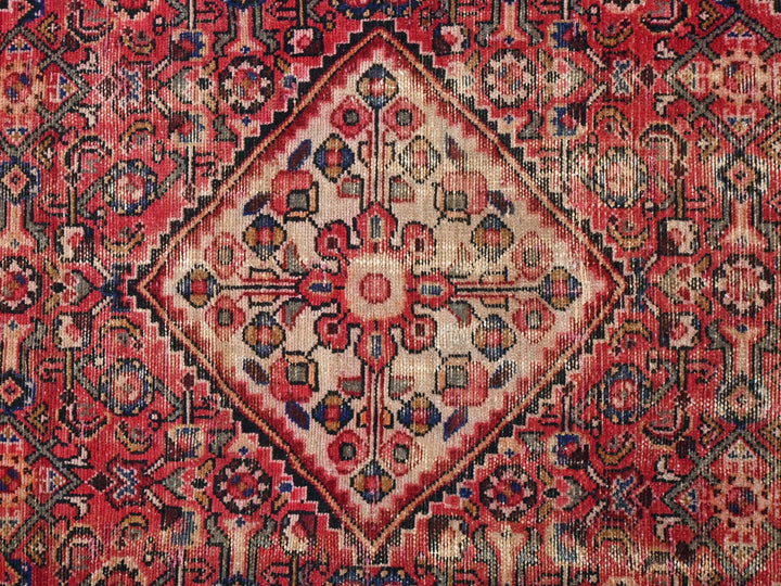 a red and blue rug with an intricate design