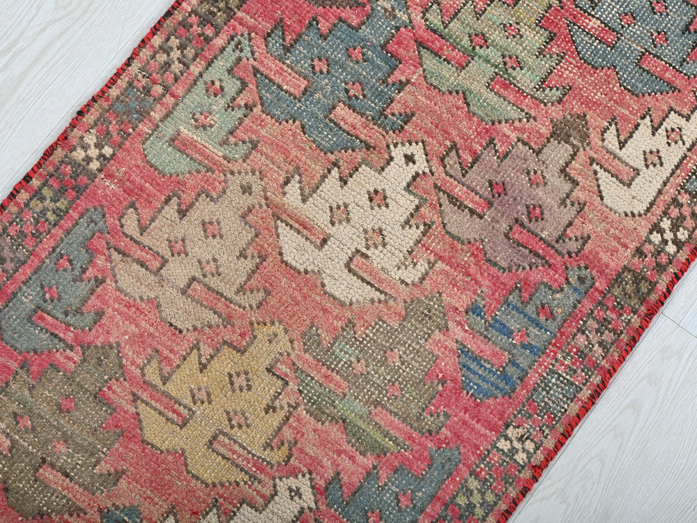 a red rug with a pattern of cats on it