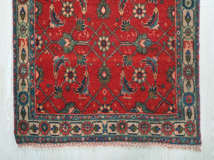 a red rug with a floral design on it