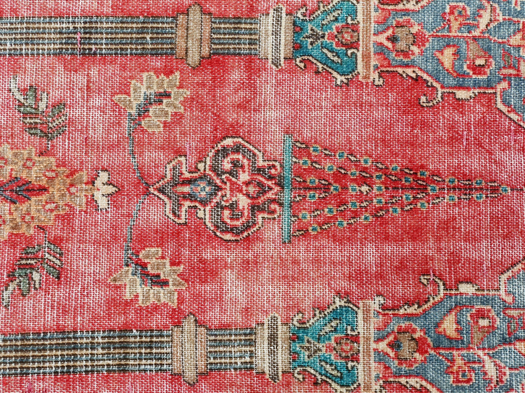 a close up of a rug with a red background