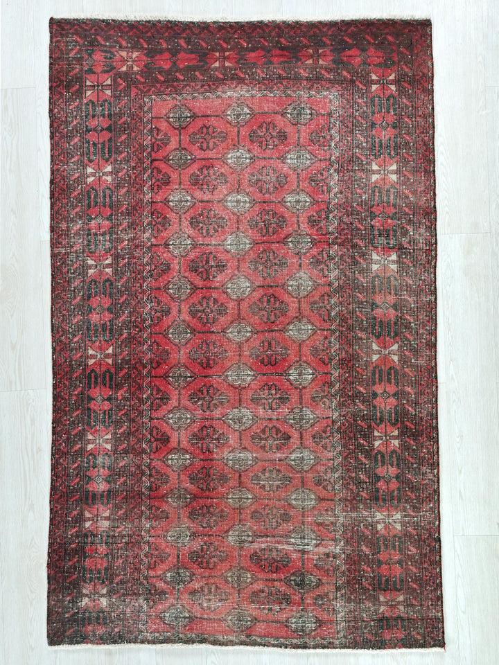a red rug with a pattern on the middle of it
