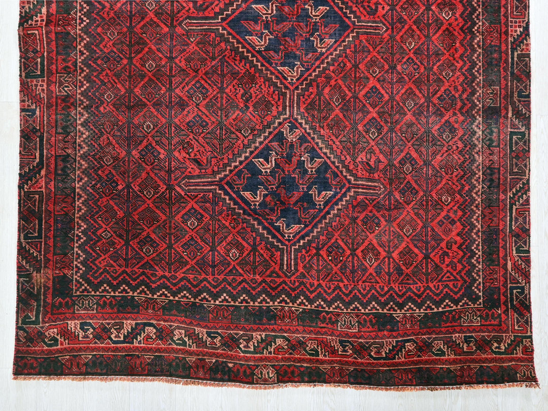 a red rug with a blue and red design