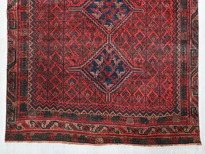 a red rug with a blue and red design
