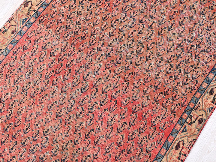 a red and blue oriental rug on a wooden floor