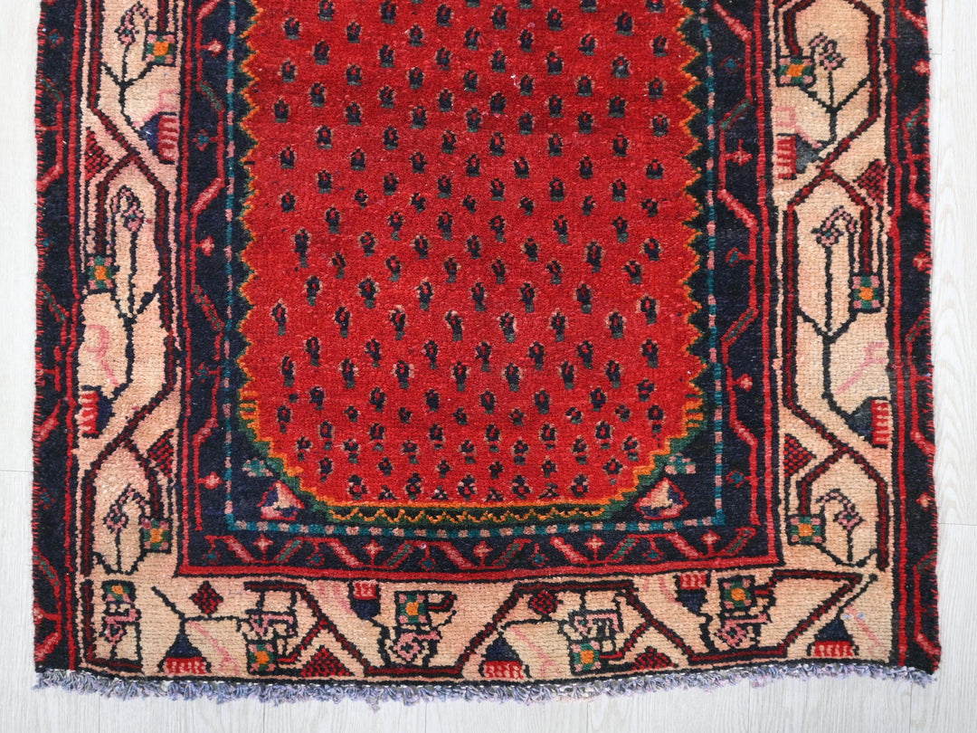 a red and blue rug on a white floor