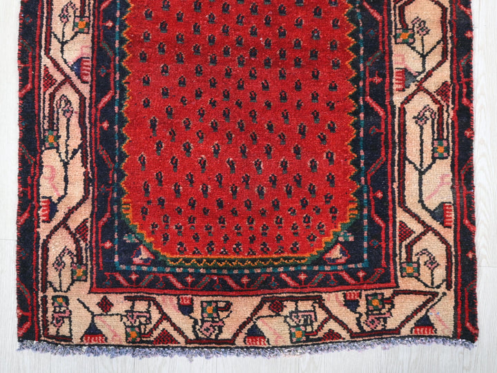 a red and blue rug on a white floor