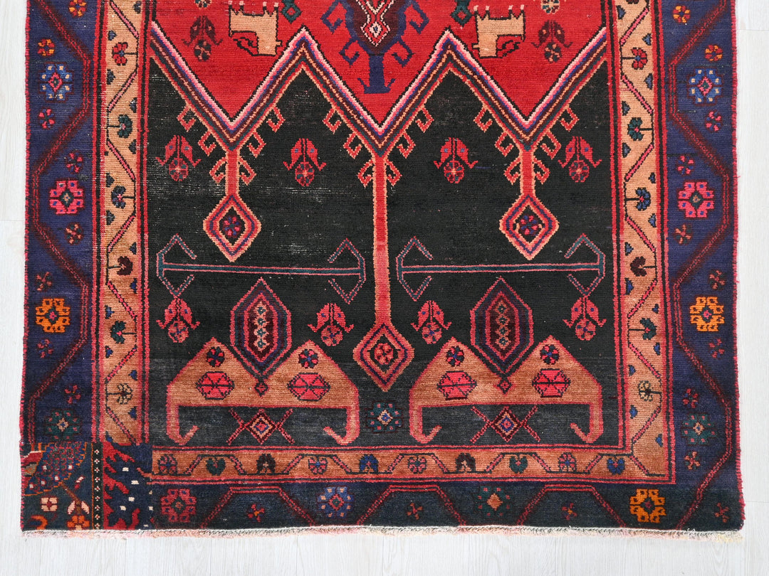 a red and black rug on a white background