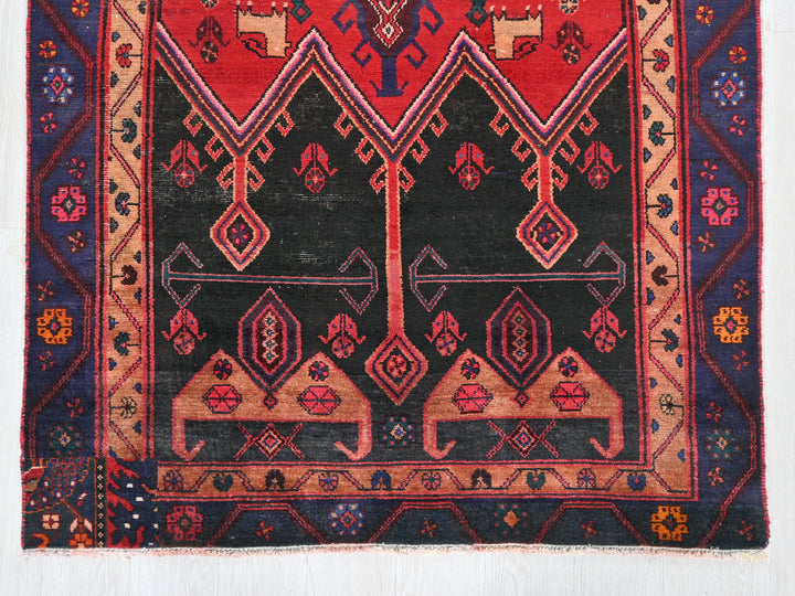 a red and black rug on a white background