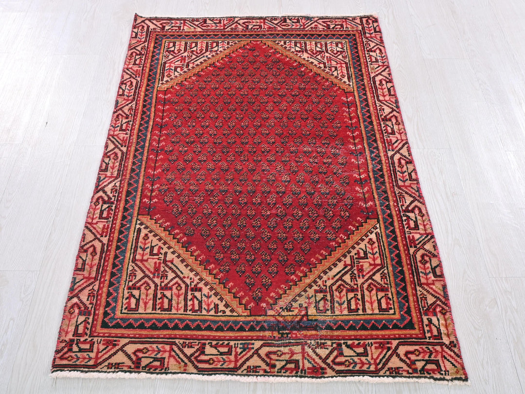 a red rug on a white wooden floor