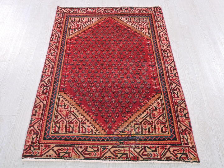 a red rug on a white wooden floor