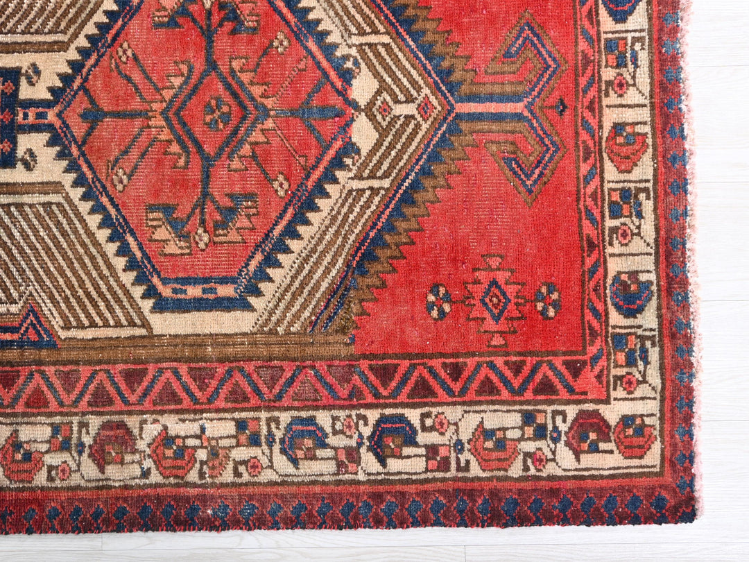 a red and blue rug on a white surface