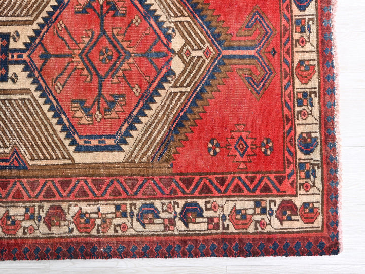 a red and blue rug on a white surface