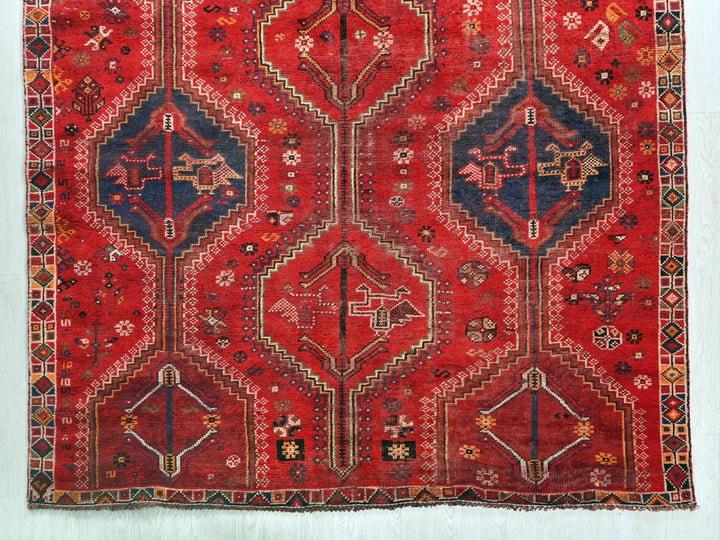 a red rug with a design on it