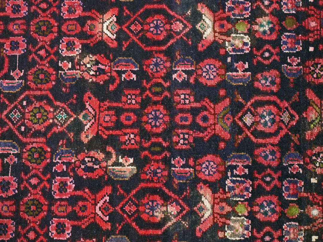 a close up of a red and black rug
