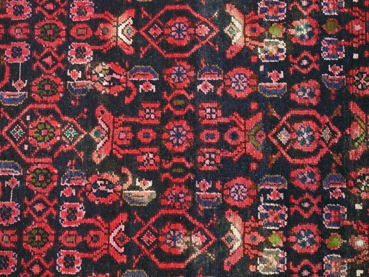 a close up of a red and black rug