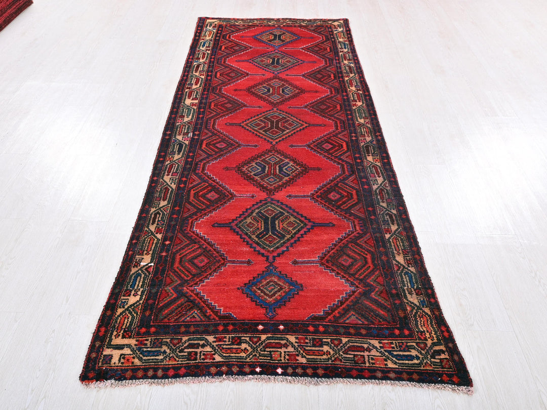 a red runner rug on a white floor