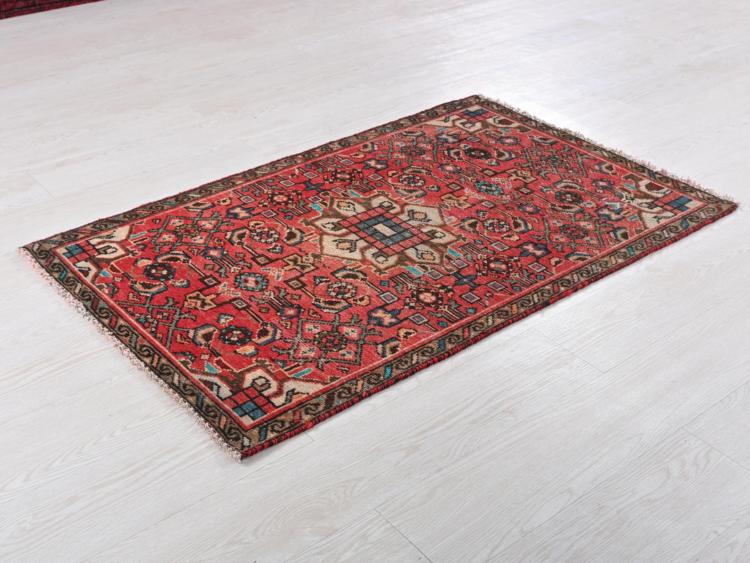 a red rug is laying on a white floor
