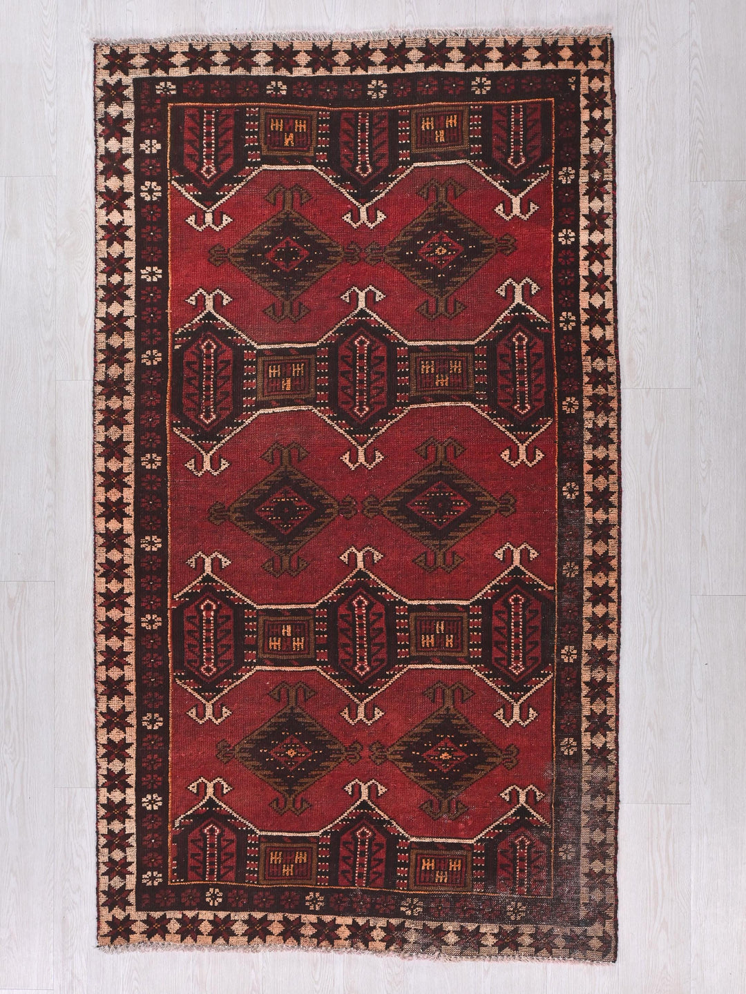 a red rug with a design on it