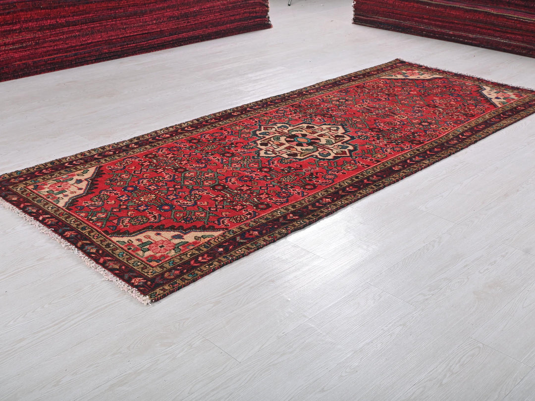 a red rug on the floor of a room