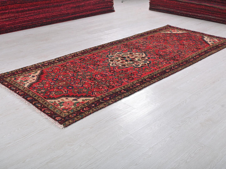 a red rug on the floor of a room