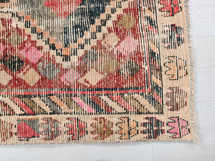 an old rug is laying on a white surface