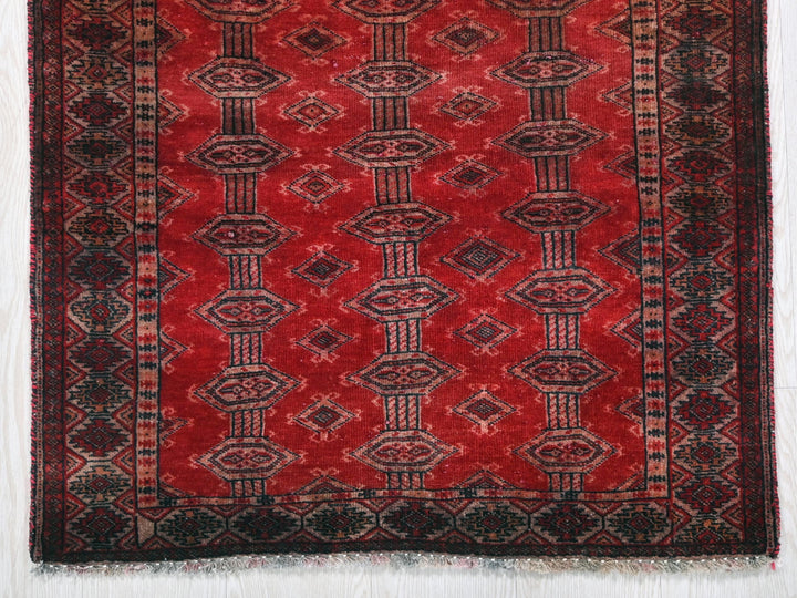 a red rug with a pattern on it