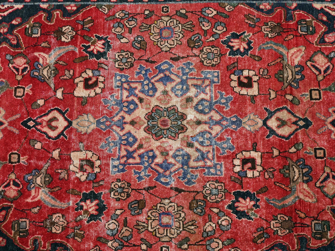 a red rug with a floral design on it
