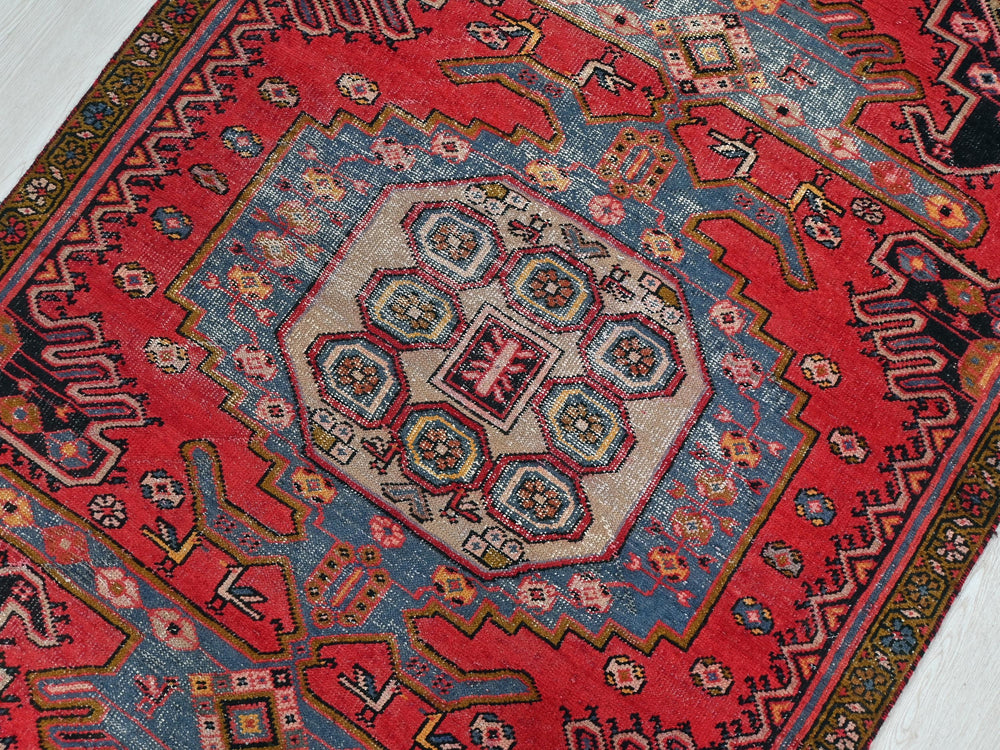 a red rug with a colorful design on it