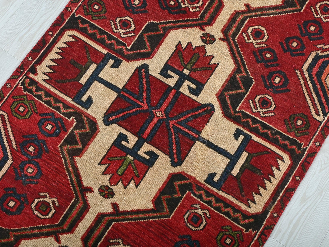 a red and black rug on a white floor