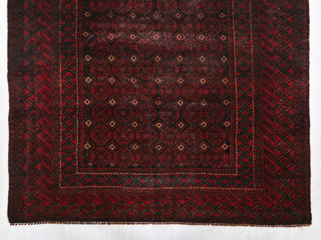 a red and black rug on a white floor