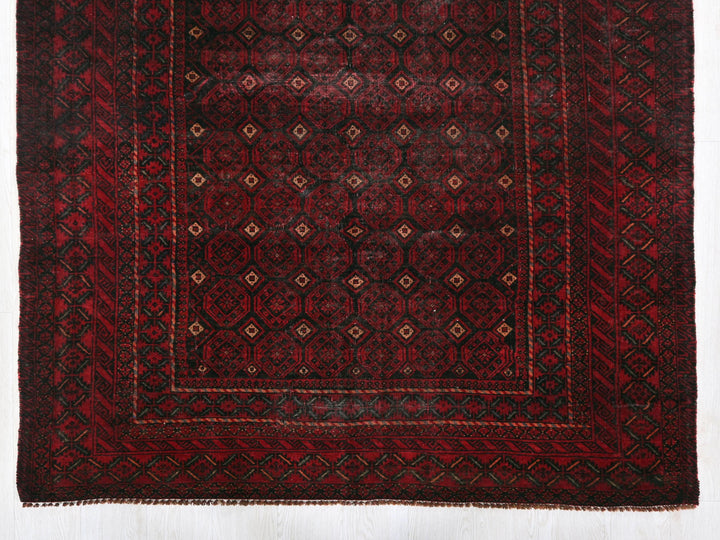 a red and black rug on a white floor