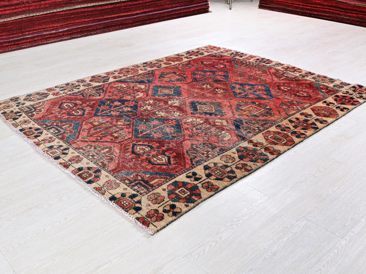 a red and blue rug on a white floor