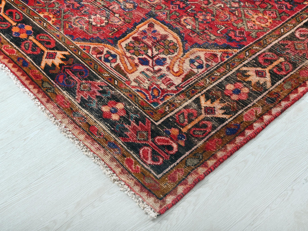 a red rug with a blue and red design on it