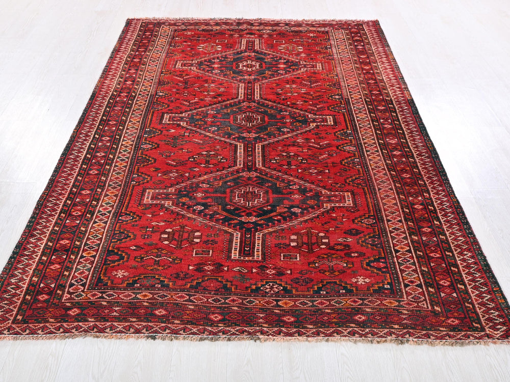 a red rug with a diamond pattern on it