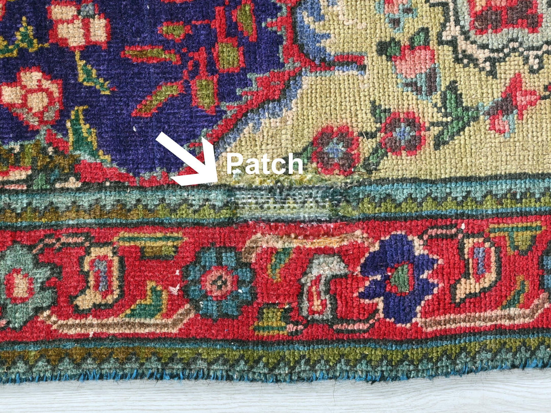 a close up of a rug with a patch in the middle