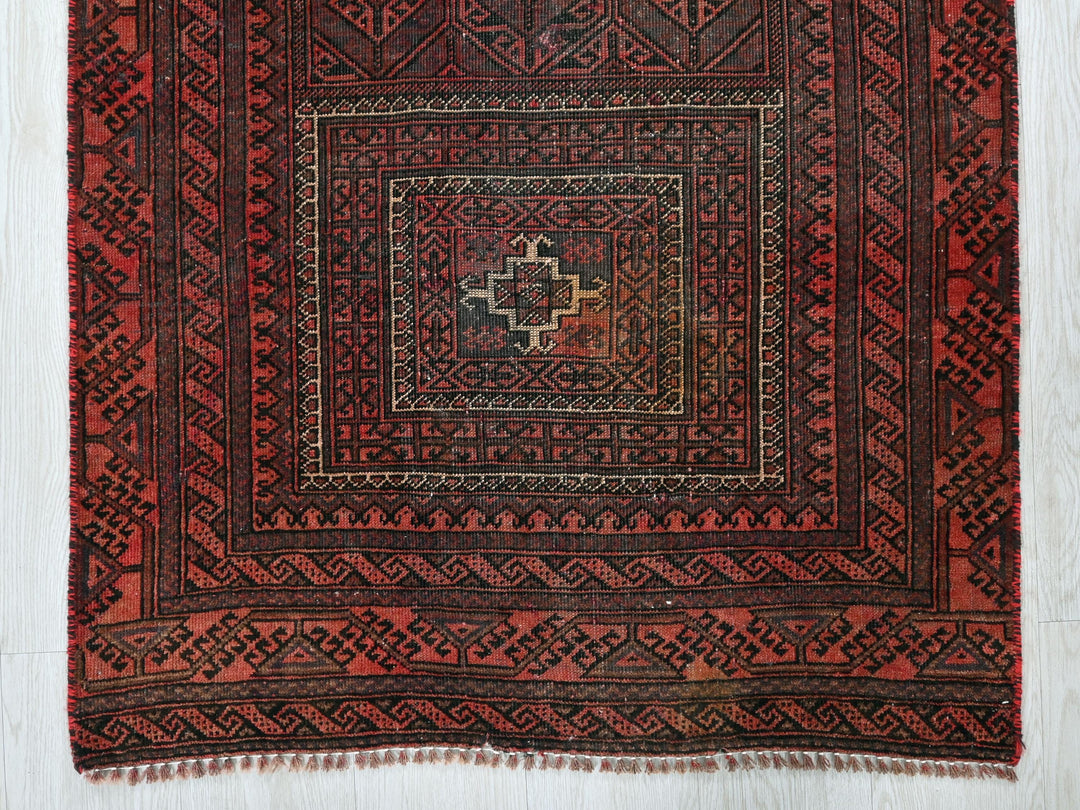 a red rug with a square design on it