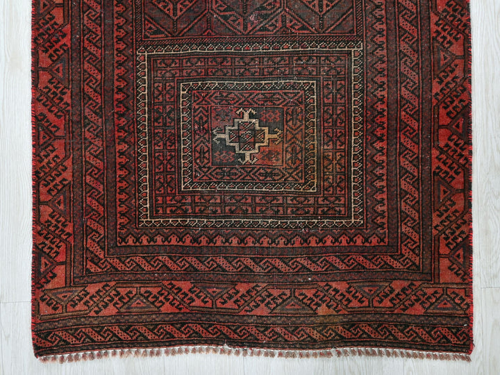 a red rug with a square design on it