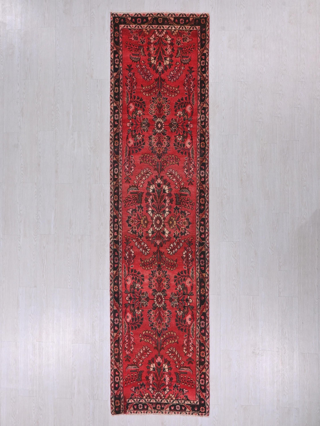 a red rug hanging up against a wall
