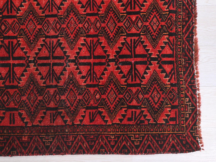a close up of a red and black rug