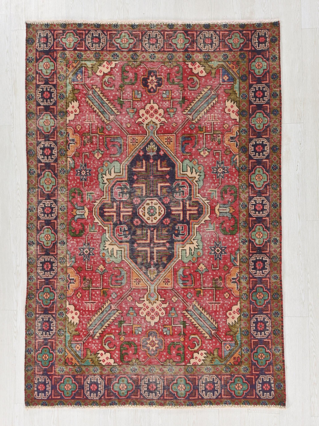 a red rug with an intricate design on it